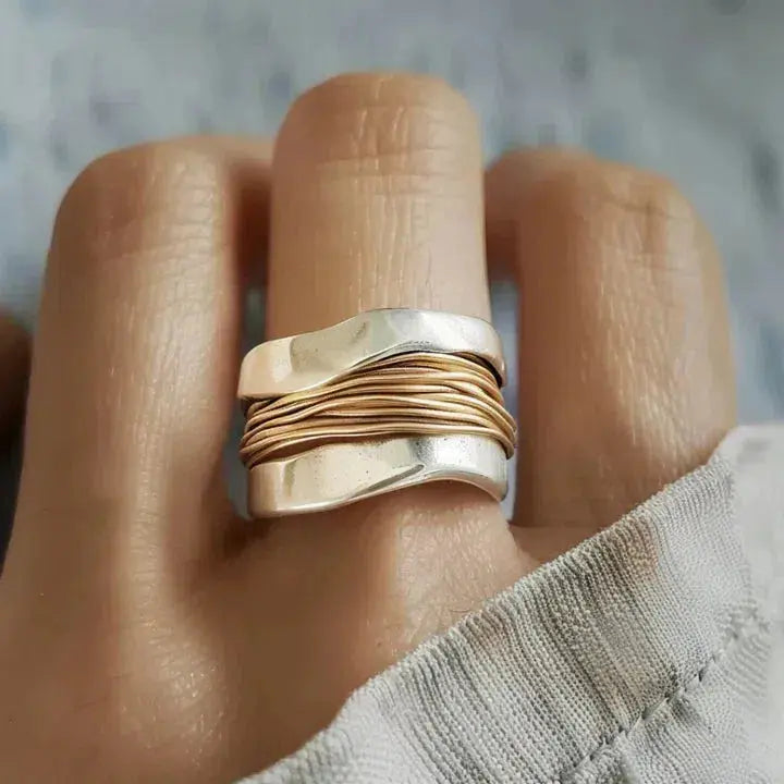 Silver ring adorned with golden strands