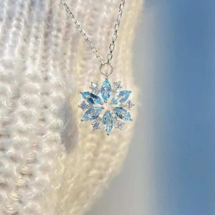 White Gold Floral Pendant Necklace Featuring Blue Snowflake Detail